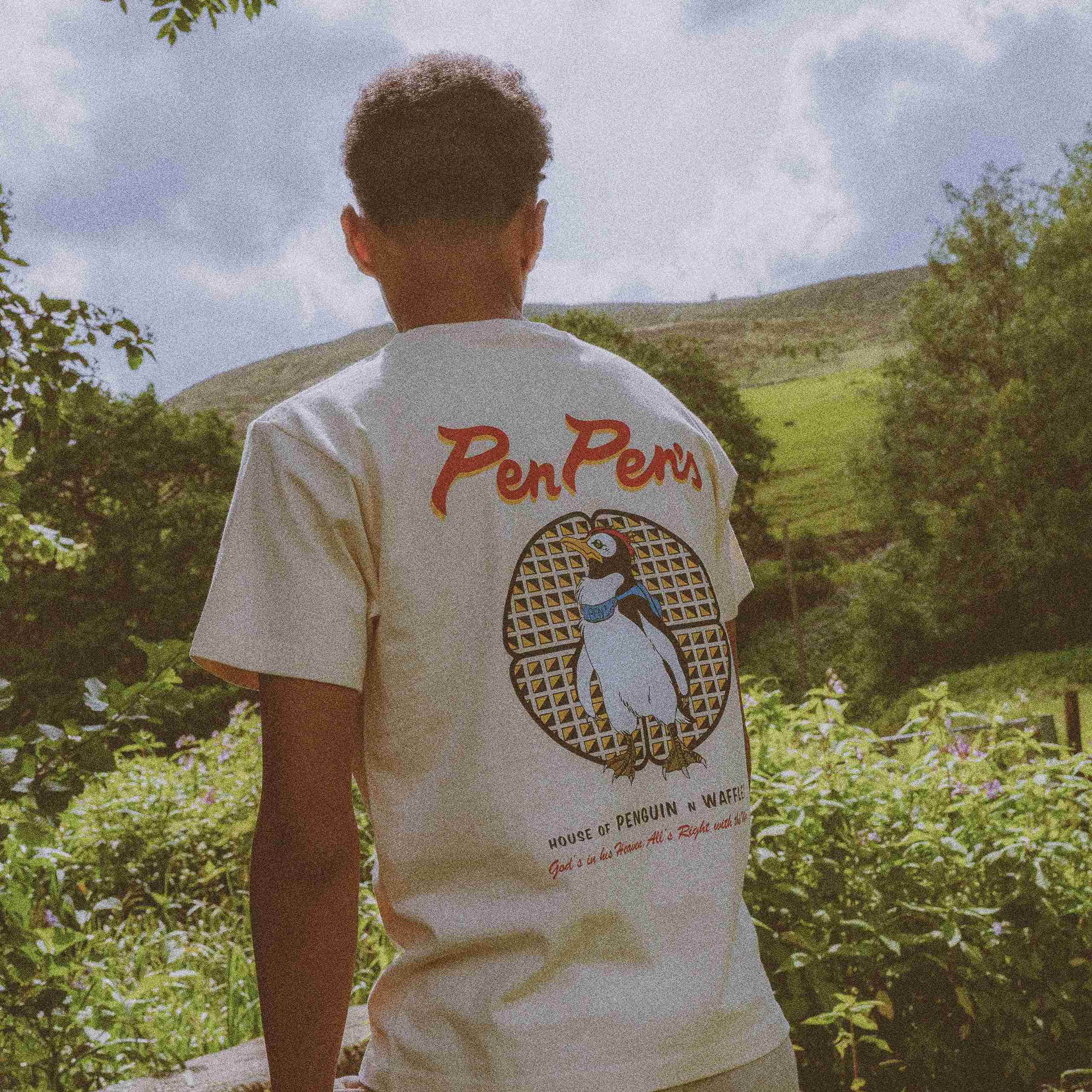 Model wearing an Evangelion 'PenPen' t-shirt featuring PenPen