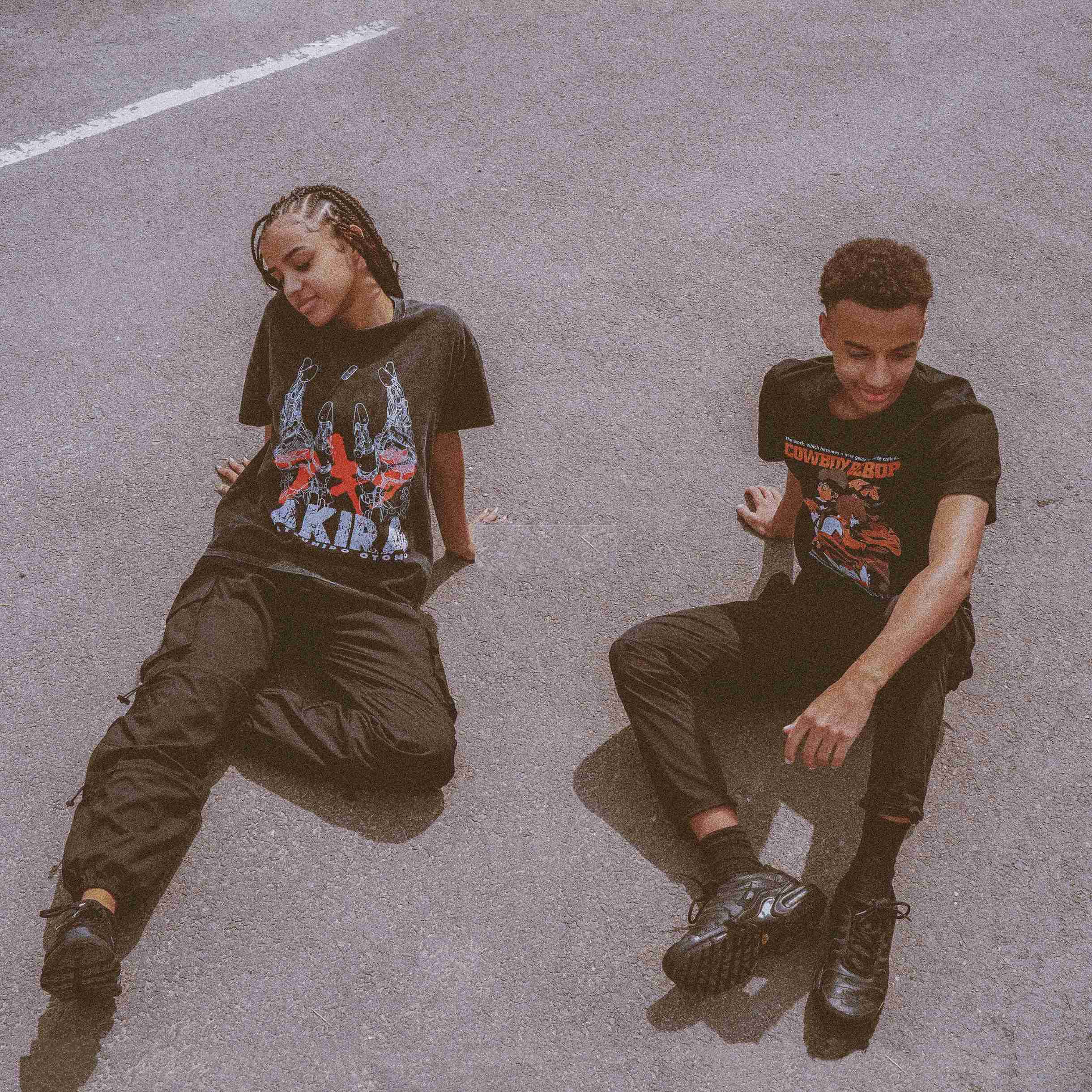 Cowboy Bebop and Akira t-shirts, worn by two models in a casual street setting.