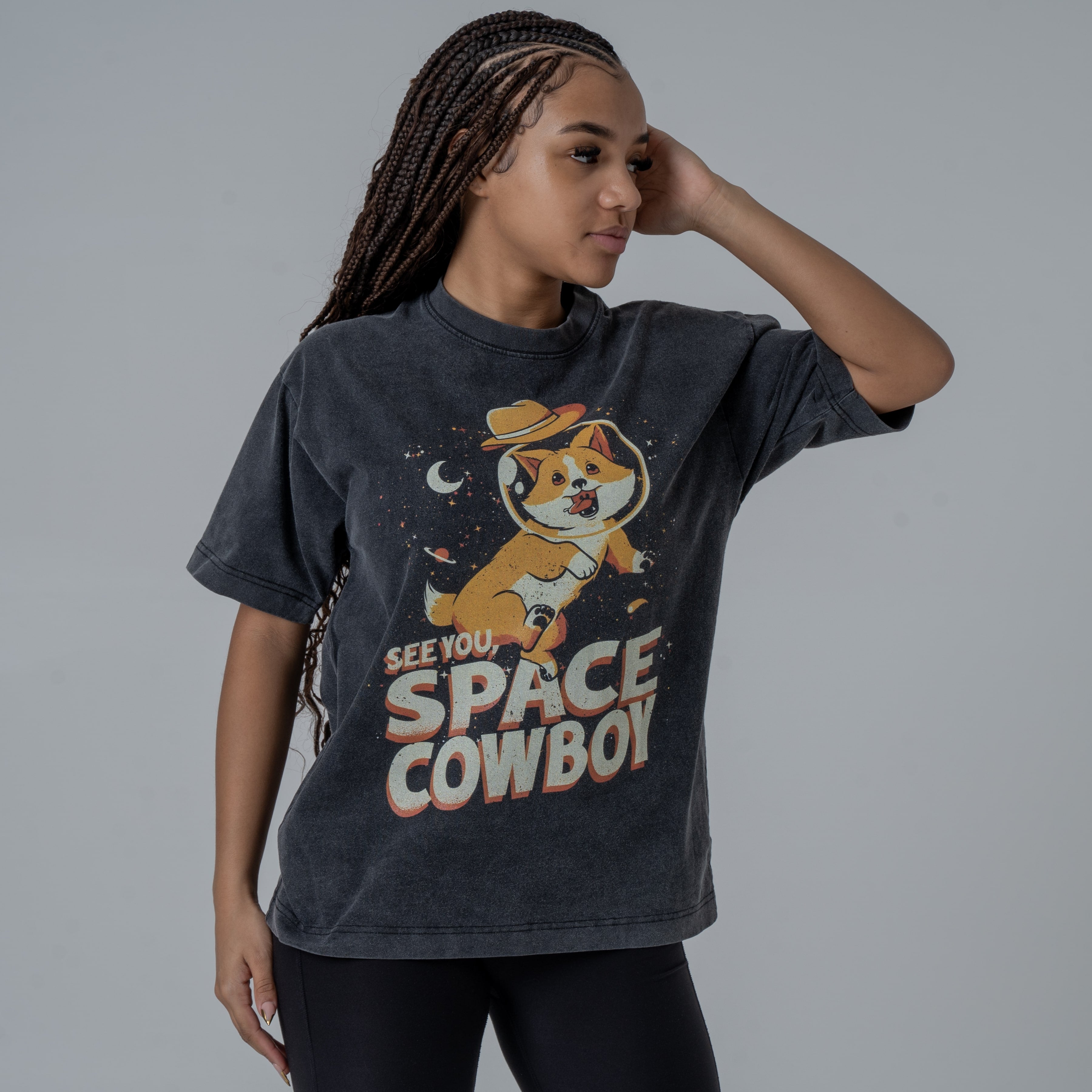 Model in a studio wearing black vintage washed T-Shirt featruing colorful graphic of Ein from CowBoy Bebop with See You Space Cowboy text.