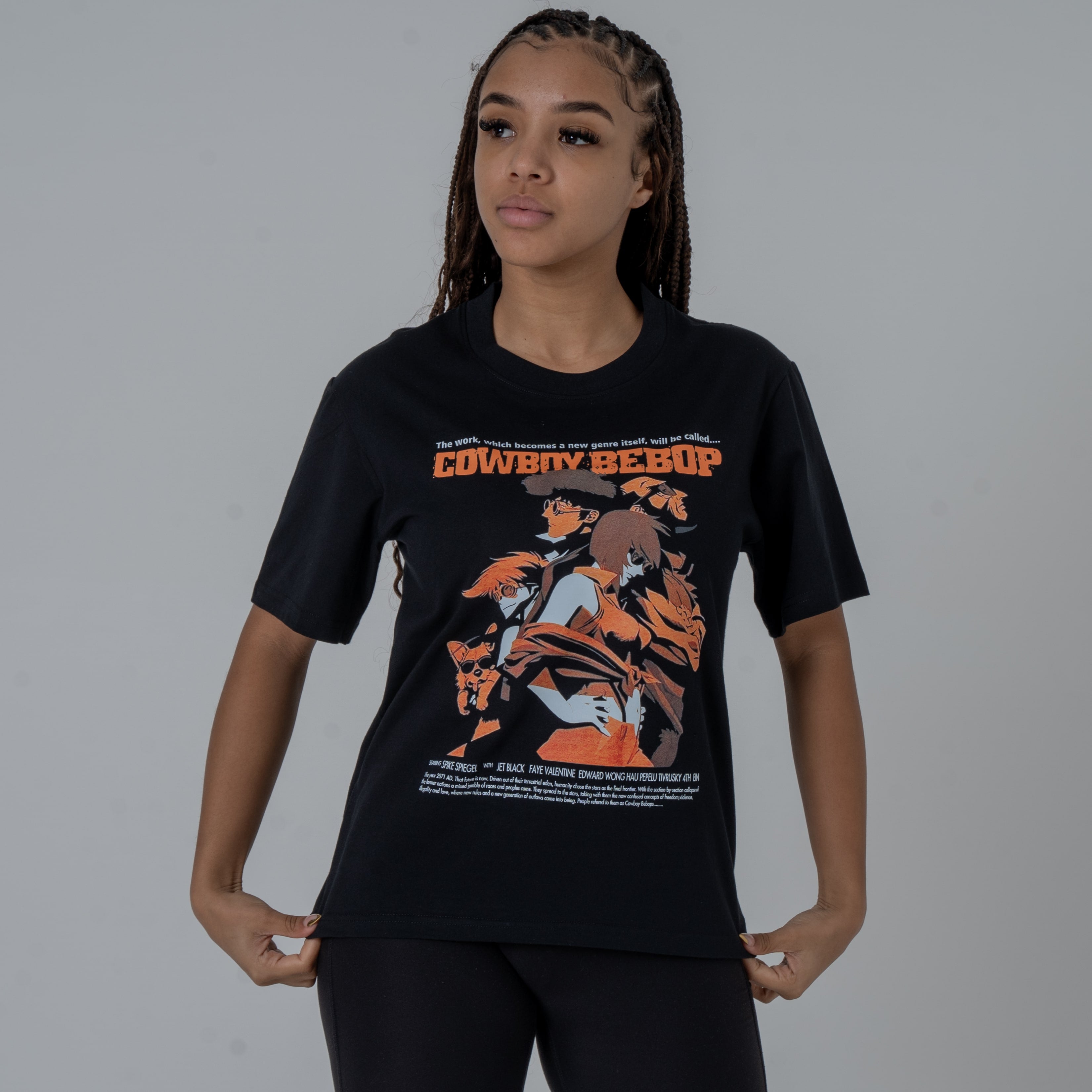 front view of a female model in a studio wearing a black anime T-shirt with an orange Cowboy Bebop graphic featuring the main characters with the Cowboy Bebop text.